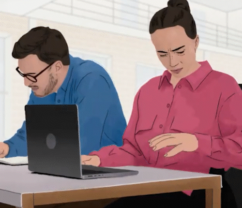 Two people at a desk, one of them looking down at her hands with worry